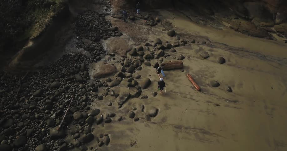 Aerial view of people walking on a rocky beach