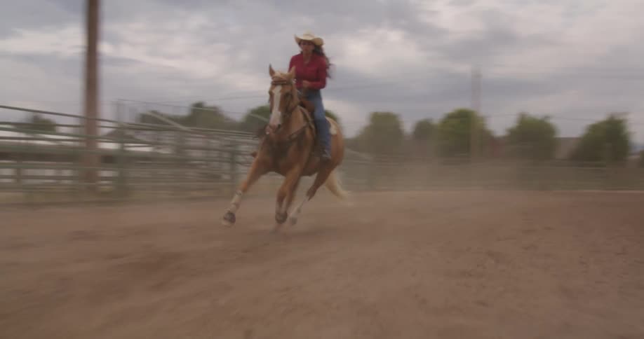 Cowgirl riding a horse in a rodeo