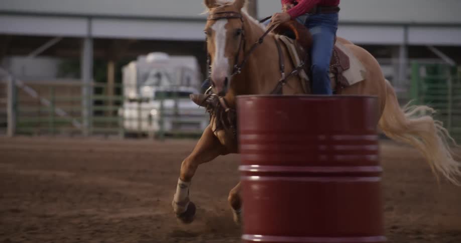 A female on a horse riding and training it to run