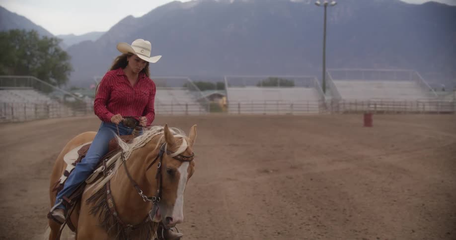 Cowgirl riding a horse in a rodeo