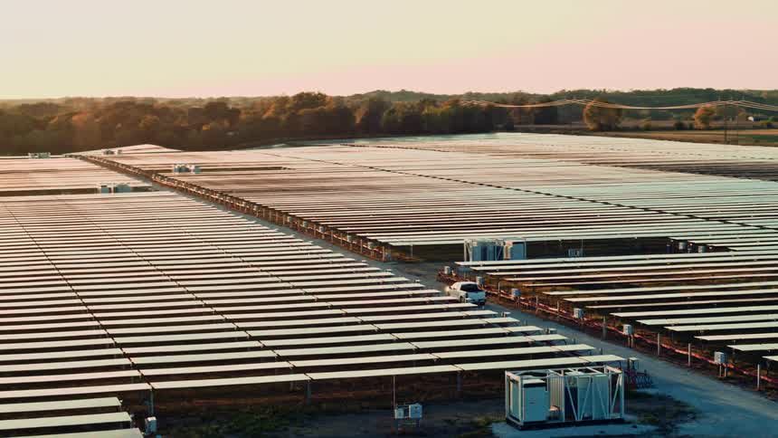 Aerial view of a truck driving through a solar farm