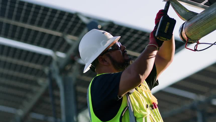 Construction worker repairing a solar panel