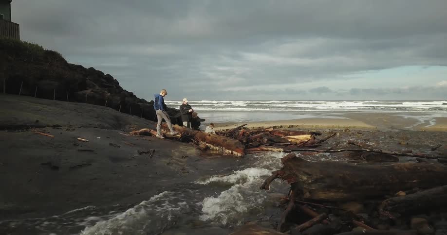 People stand near a stream by the beach