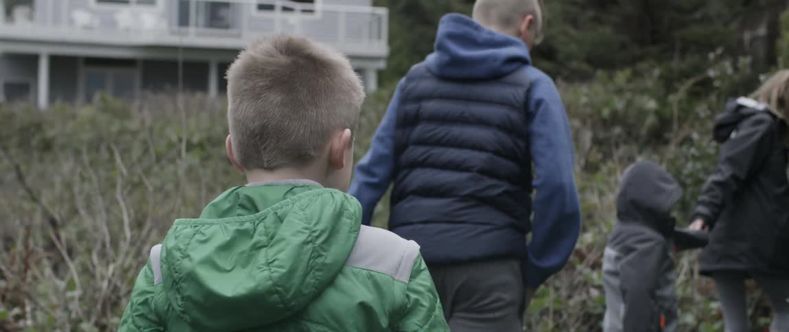 Kids walking on a path through shrubbery