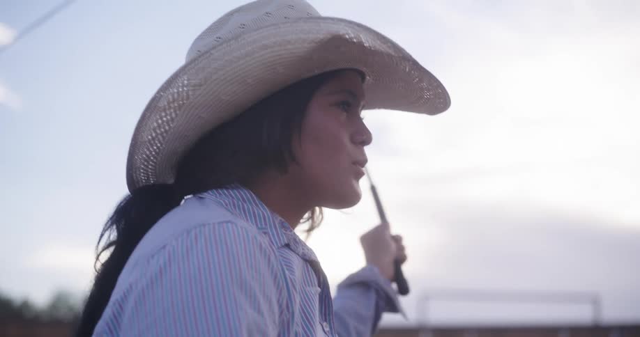 A woman is carrying a whip on the farm