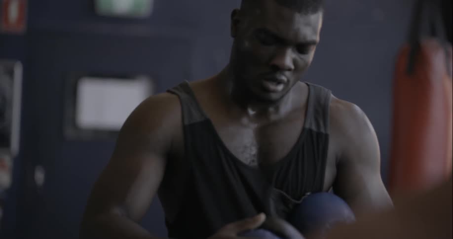 Man puts on boxing gloves