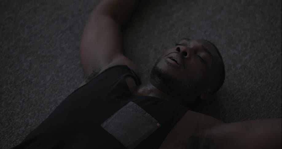 A man is doing sit ups then rests