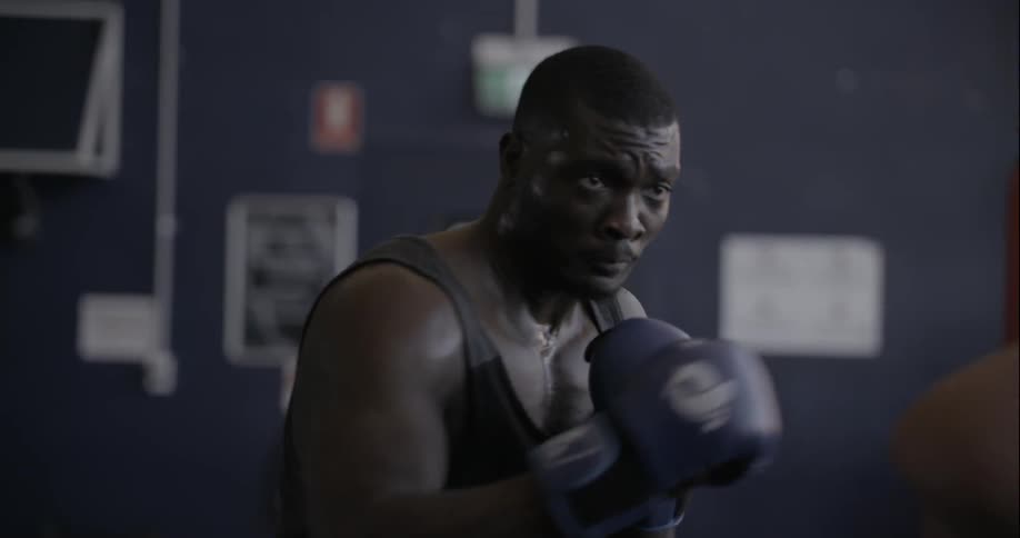 A man is boxing a dummy
