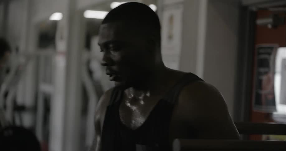A man is working out sweating in a gym