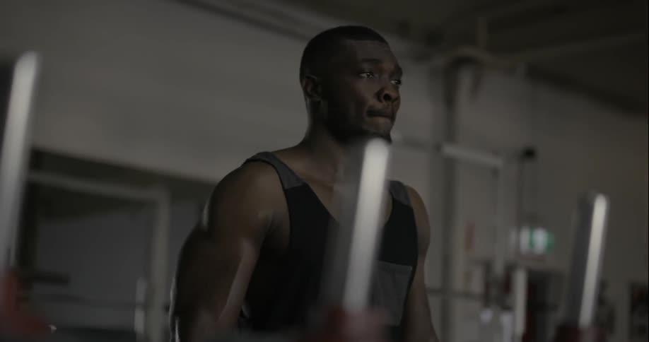 A man is curling a dumbbell