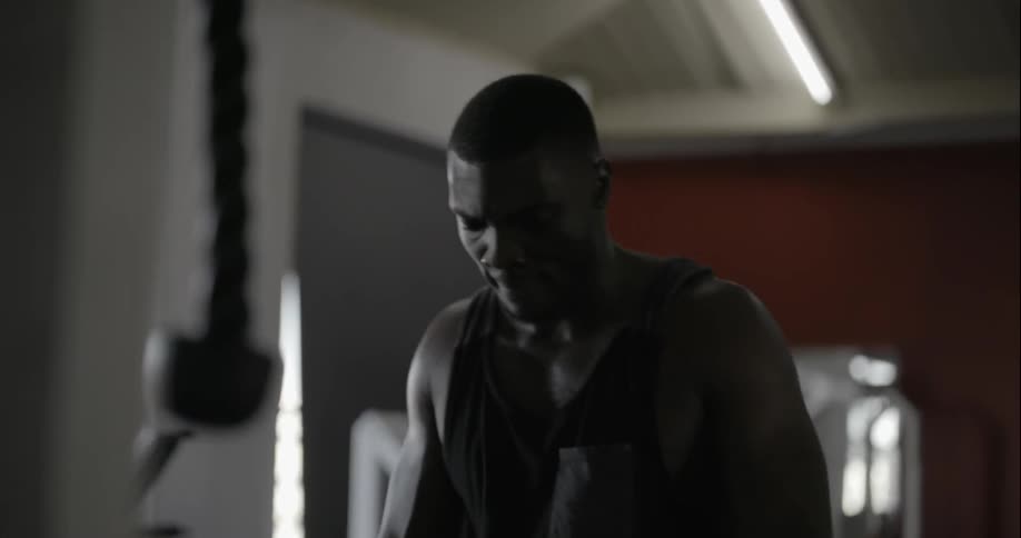 A man is stretching in a gym