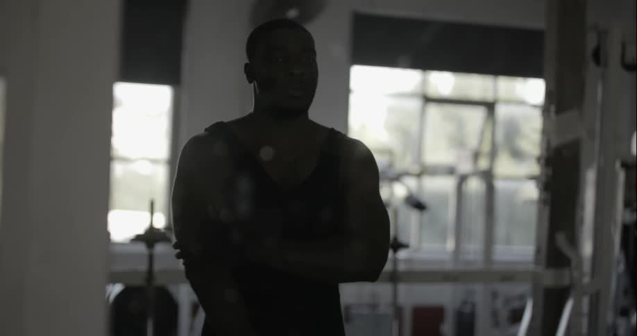 A man puts some weights down in a gym