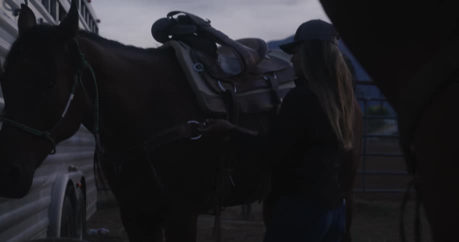 Woman adjusting her horse with reins