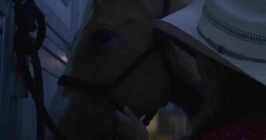 Cowgirl greets her horse in the morning