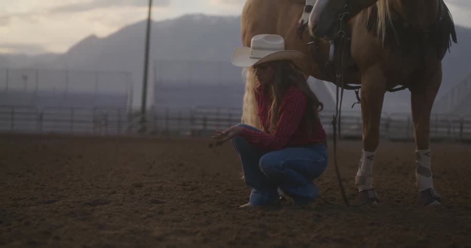 A woman beside her horse sampling the soil
