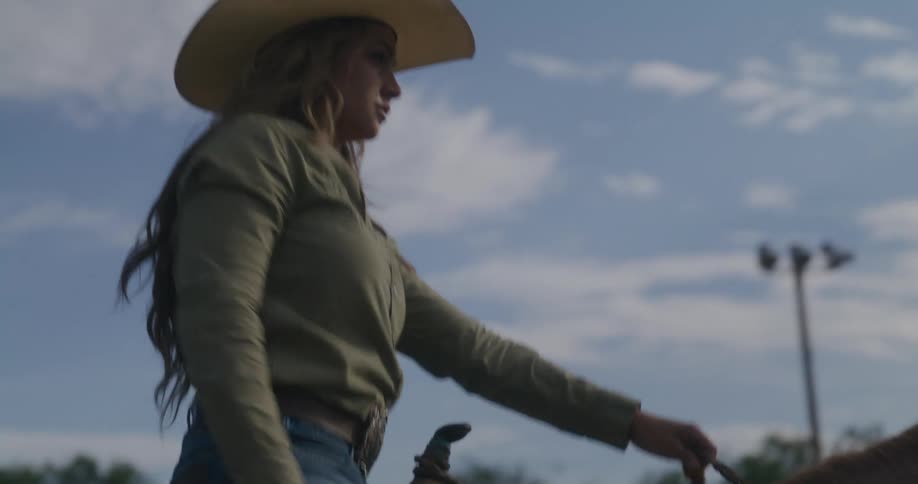 Cowgirl rides a horse in the rodeo