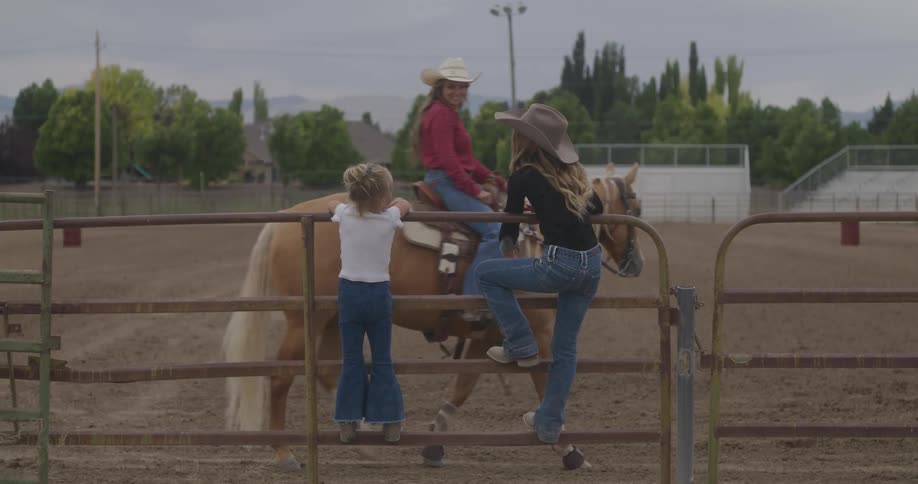 Children see a woman on a horse riding through the arena