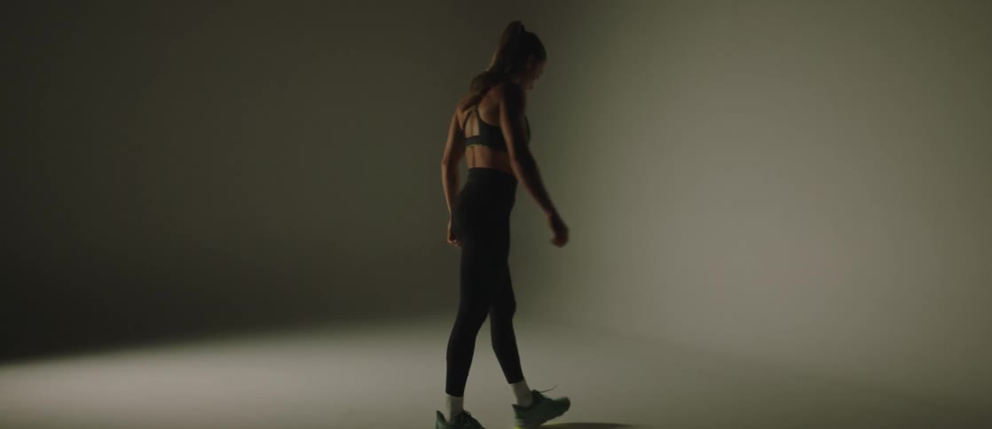 A woman walking in circles in a dark room