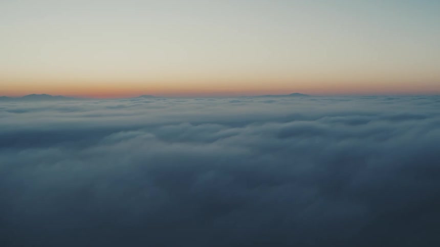 Aerial view above the clouds with a morning sky