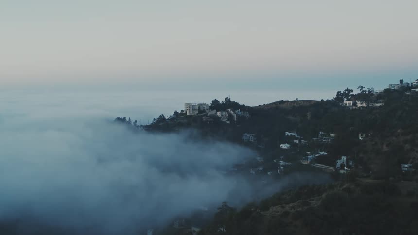 Fog creeps into the Hollywood Hills at dusk blue hour