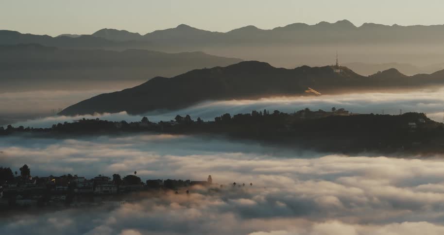 Aerial view of clouds over the suburbs in the hills at morning
