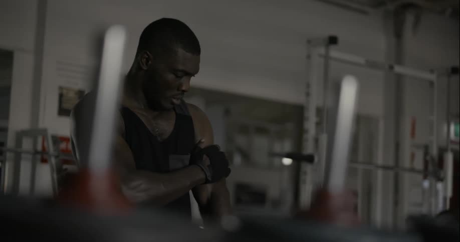 A man is stretching in a gym