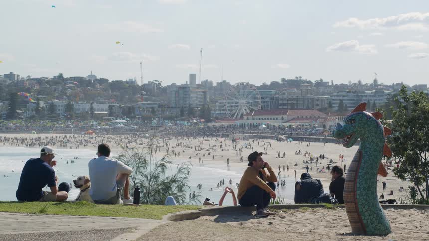 People enjoying the beach next to the city