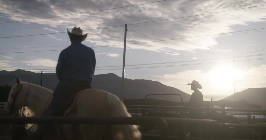 Two cowboys on their horses at morning