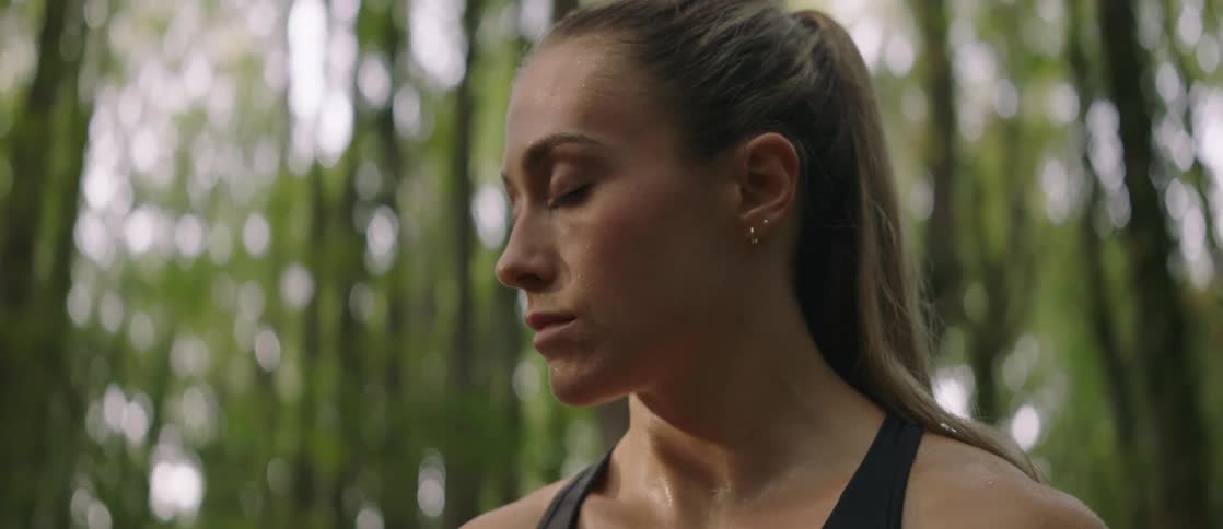 Portrait of a woman with her eyes closed concentrated and in a forest