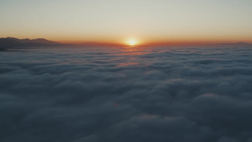 A view above the clouds of a bright sun