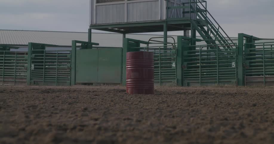 Red metal barrel in the middle of the rodeo