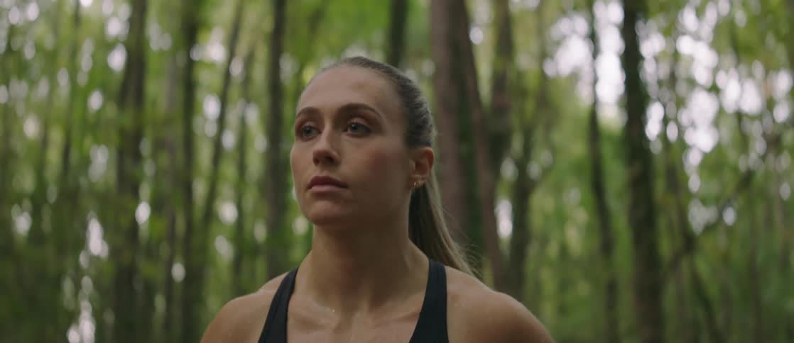 Fit woman jogs in the forest