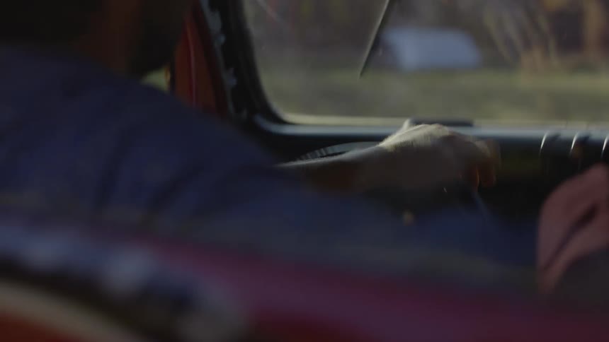 Close up of the steering wheel of a car driving in the countryside