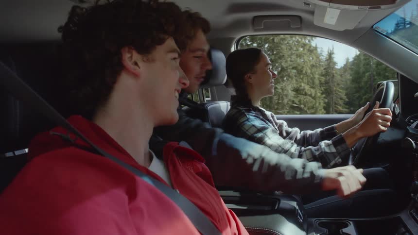 A girl driving the car on a trip with friends