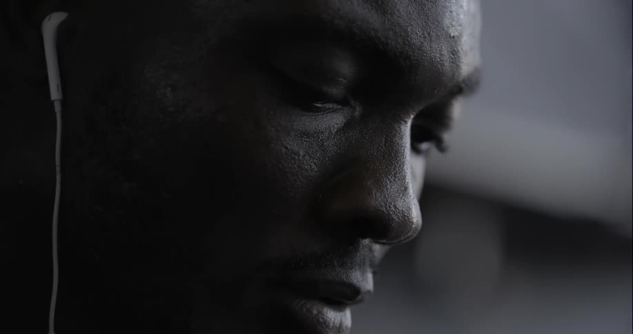 Close-up of a man listening to something through his earbuds