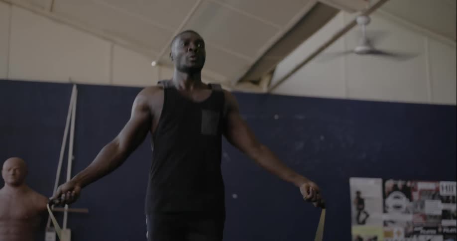 A person is jumping rope in a gym