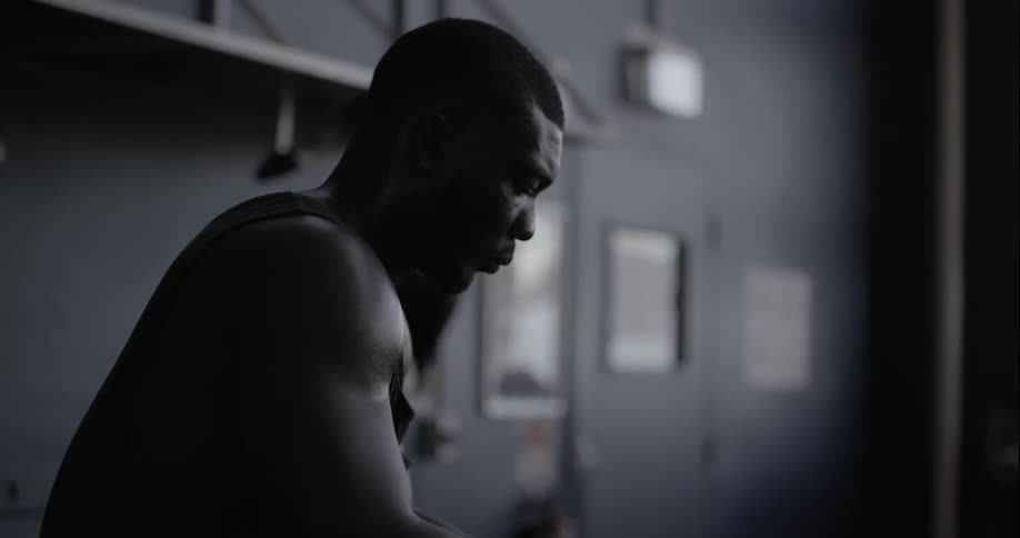 A man is sitting in a gym