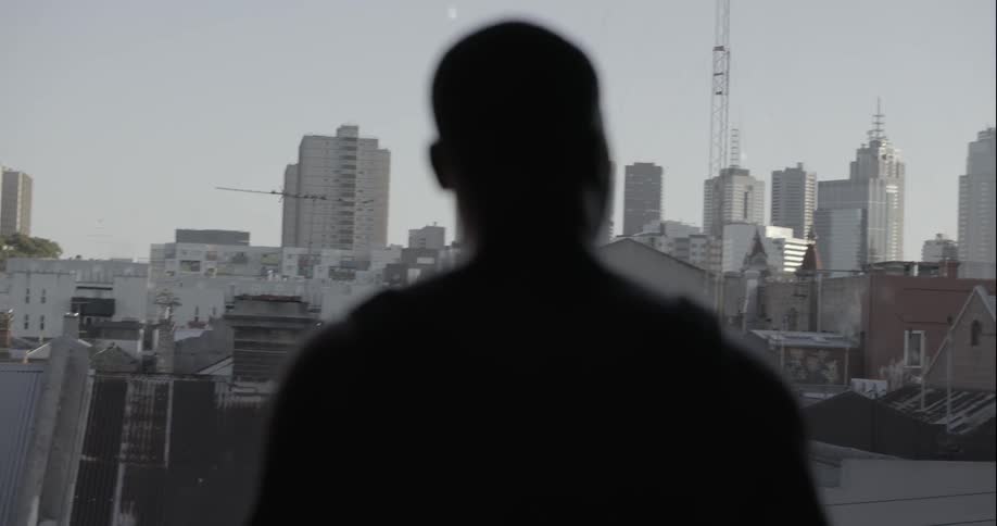 A man looks over a large city ahead