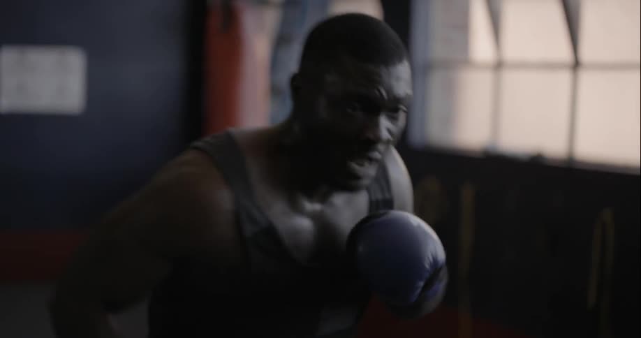 Boxer practicing his trade with a dummy