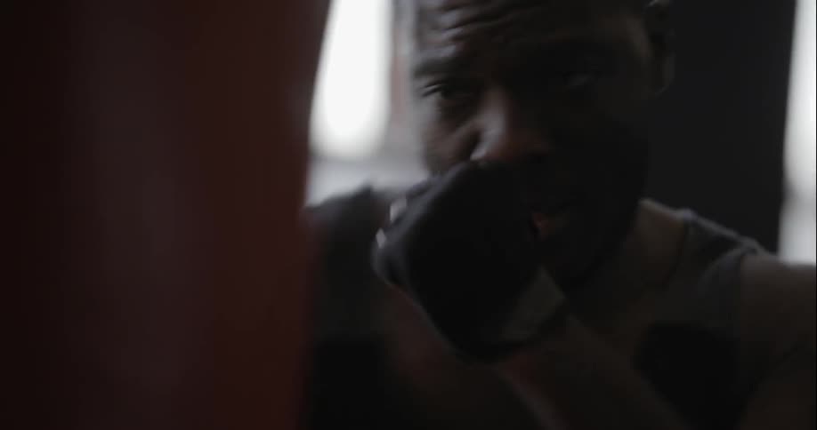 Man working out with a heavy bag