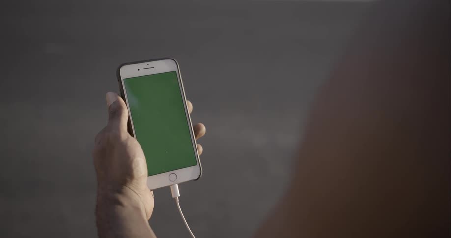 Person using their smartphone as traffic goes by