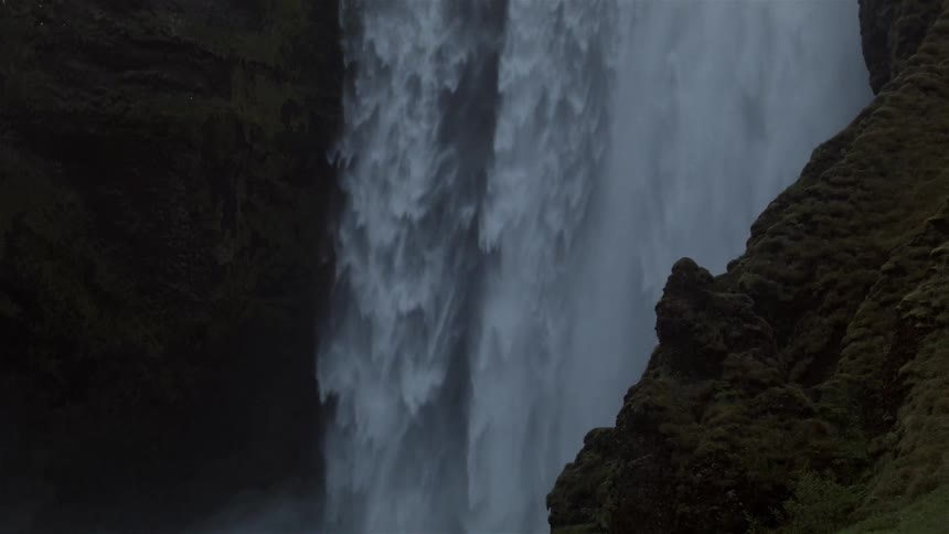 A waterfall is very wide and surrounded by rocks