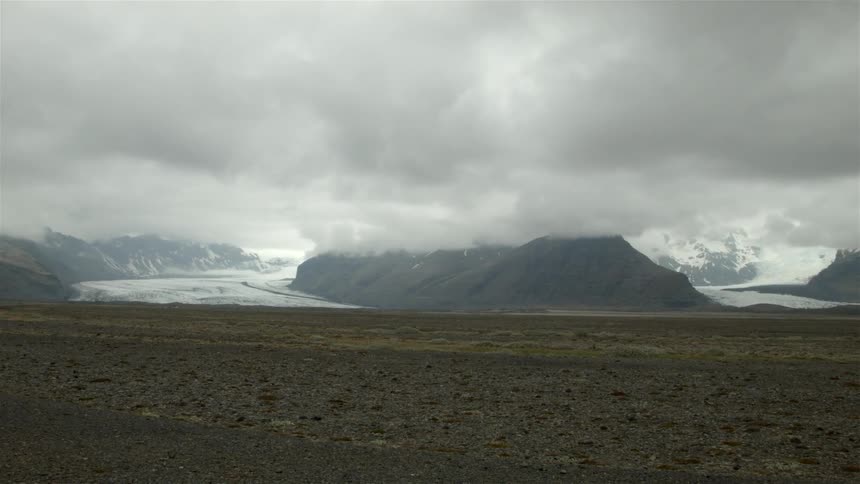 Dark clouds loom over the mountains