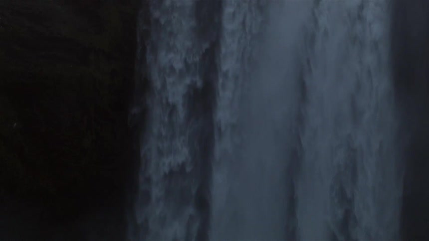 The water slowly pours from a waterfall