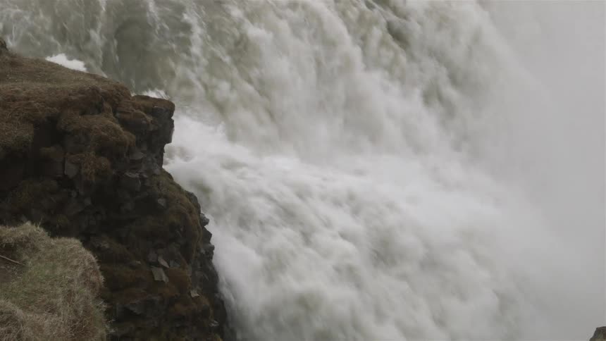 Rushing waters flow over a cliff