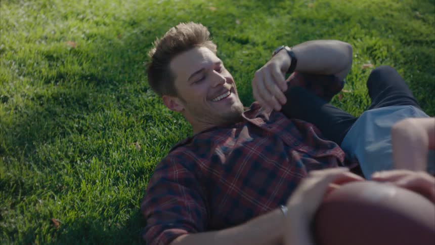 Father wrestles playfully with his kids on the lawn