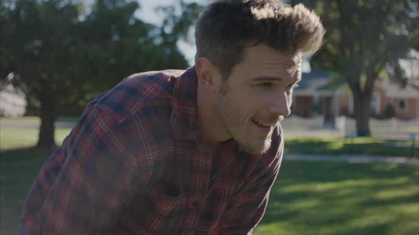Happy man tired while playing with his son at the park