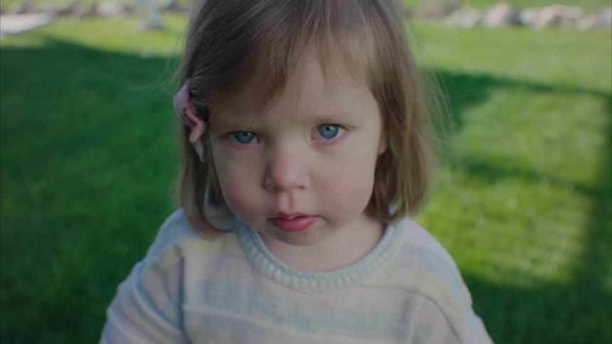 A little girl with a pink hair bow