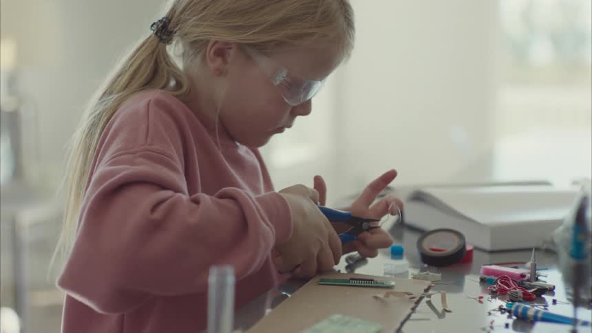 A girl in a laboratory repairing electronics