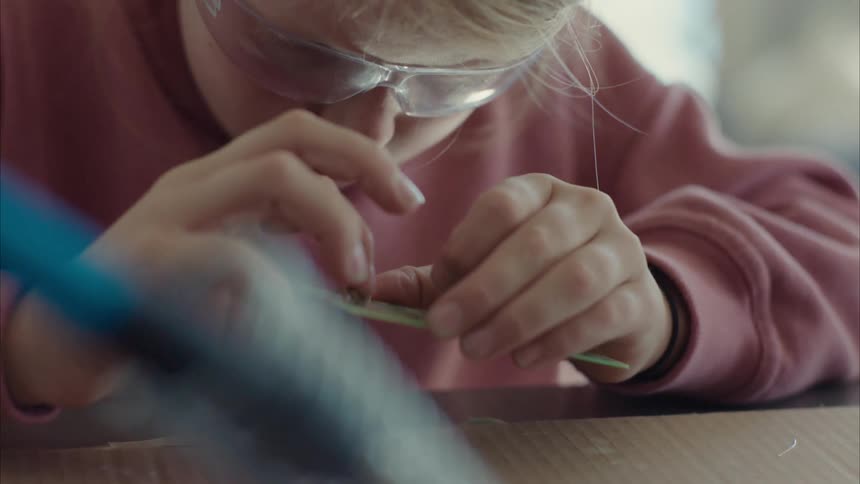 Girl holding an object and connecting it to a software prototype